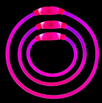 Set of three pink illuminated light up dog collars in small, medium, and large sizes nested together high visibility safety collars for walking in low light.