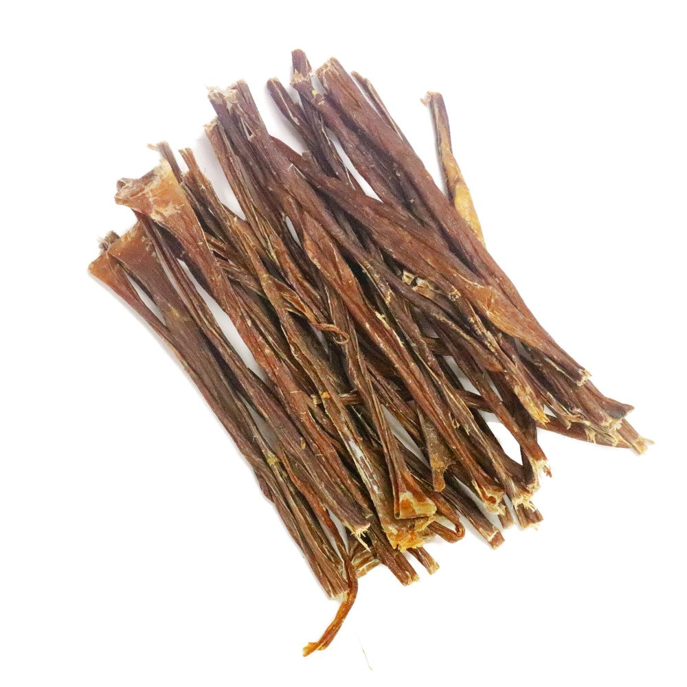 Pile of natural pork straws dog chews high protein low fat crunchy air dried treats for teeth and gums and chewing enrichment.